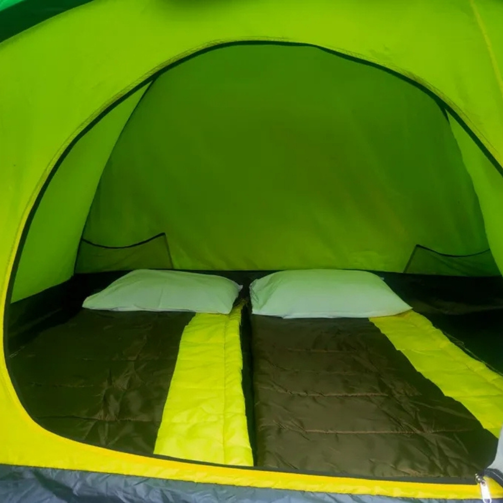 Interior view of a tent with two sleeping bags and pillows.